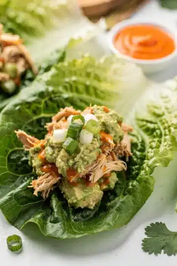 Buffalo Avocado Chicken Salad Lettuce Wraps 11 Creamy buffalo avocado chicken salad in crisp lettuce wraps close up