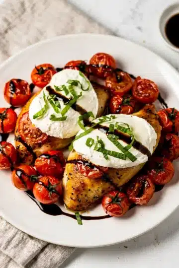 Caprese Baked Chicken with Fresh Mozzarella 11 Golden brown baked chicken topped with melted mozzarella and fresh basil caprese.