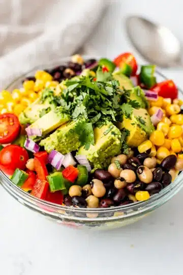 Cowboy Caviar Dip 13 Cowboy caviar dip with beans corn and vegetables in a rustic ceramic bowl