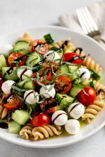 Cucumber Caprese Pasta Salad 14 Creamy cucumber caprese pasta salad with mozzarella pearls and balsamic glaze
