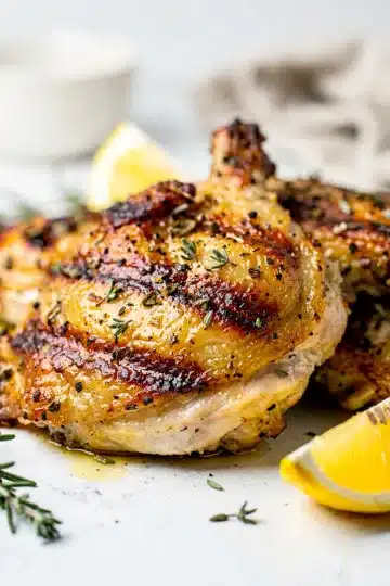 Grilled Lemon Herb Chicken Thighs 13 Grilled lemon herb chicken thighs with crispy char marks and fresh rosemary