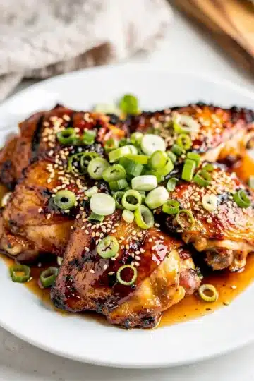 Hawaiian Huli Huli Chicken 13 Grilled Hawaiian Huli Huli chicken with glossy caramelized sauce and pineapple garnish.