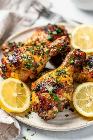 Lemon Herb Grilled Chicken Drumsticks 14 Lemon herb grilled chicken drumsticks with crispy skin and fresh lemon garnish