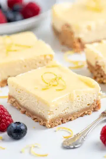 Lemon Icebox Cheesecake Bars 11 Lemon Icebox Cheesecake Bars with fresh blueberries and powdered sugar