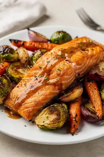 Sheet Pan Maple Dijon Salmon with Roasted Vegetables 3 Sheet pan maple Dijon salmon with roasted vegetables on parchment lined baking sheet.