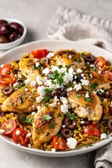 Mediterranean Chicken Orzo Skillet 14 Mediterranean chicken orzo skillet with tomatoes olives and feta in cast iron pan