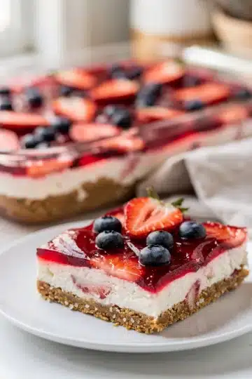 Patriotic Strawberry Pretzel Dessert Bars 13 Patriotic strawberry pretzel dessert bars with creamy cheesecake layer.