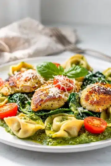 One Pan Pesto Chicken and Tortellini 6 Creamy pesto chicken and cheese tortellini in a rustic one pan dinner.