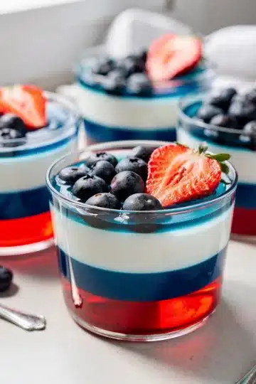 Red White and Blue Layered Jello Cups 14 Red white blue layered jello cups with fresh berries.