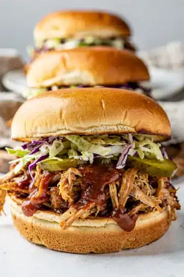 Smoky BBQ Pulled Chicken Sliders 13 Smoky BBQ pulled chicken sliders with coleslaw and a pickle spear