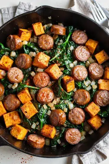 Smoky Sausage Sweet Potato and Spinach Hash 11 Smoky sausage sweet potato spinach hash, crispy browned caramelized skillet meal.