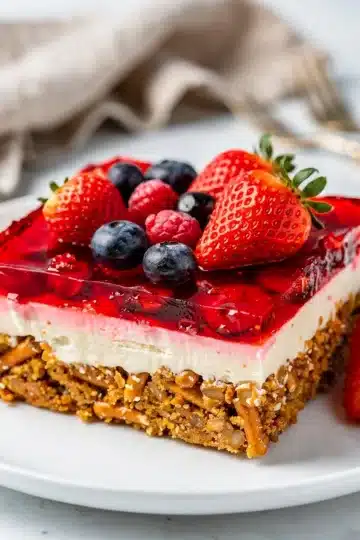 Strawberry Cream Cheese Pretzel Salad Bars 13 Strawberry cream cheese pretzel salad bars, glossy ruby topping.