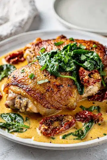 Tuscan Sun-Dried Tomato Chicken Thighs 11 Crispy chicken thighs in creamy garlic parmesan sauce with sun dried tomatoes