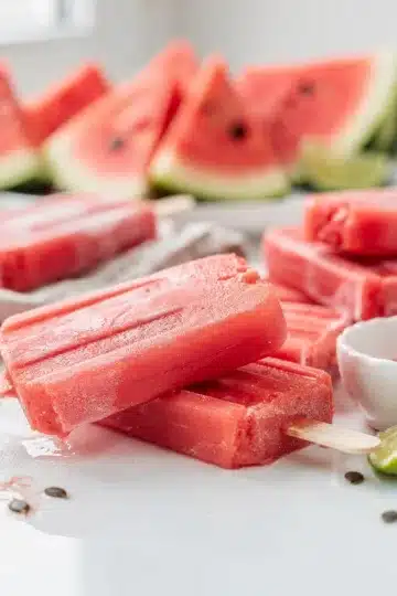 Watermelon Sorbet Popsicles 11 Refreshing watermelon sorbet popsicles on a bright clean summer table.