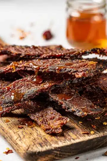 Honey BBQ Beef Jerky 11 Honey BBQ Beef Jerky close-up on rustic wooden board
