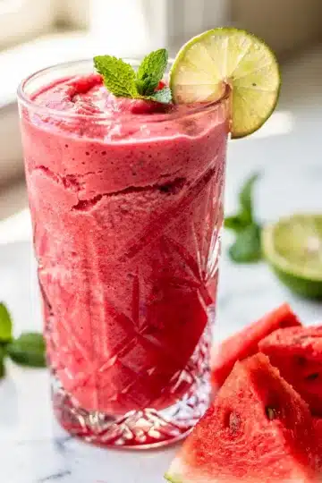 Watermelon Mint Refresher Smoothie 12 Creamy watermelon mint refresher smoothie in clear glass condensation.