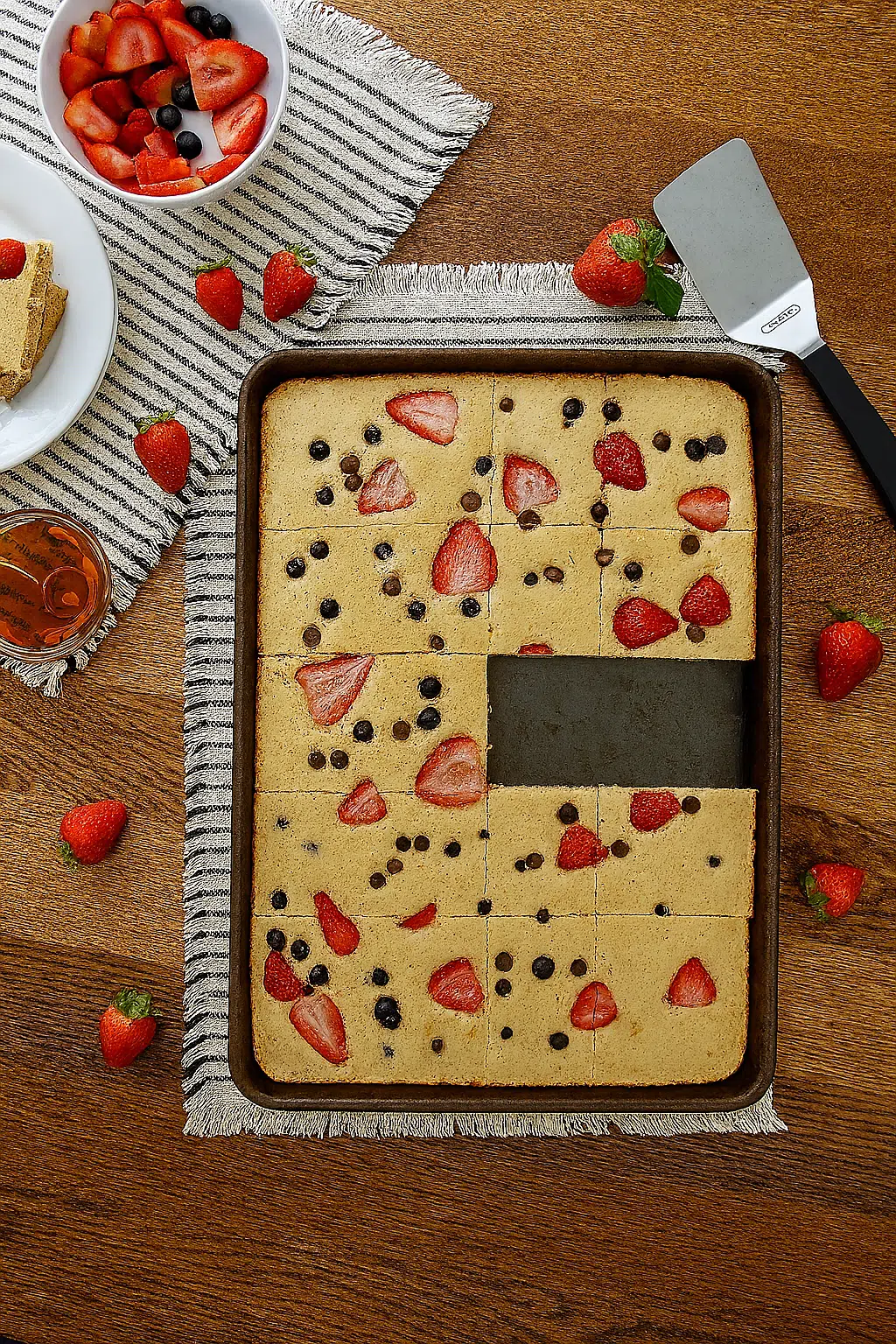 Sliced sheet pan Kodiak pancakes with strawberries, blueberries, and chocolate chips