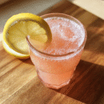 A glass of pink Himalayan salt weight loss drink with lemon