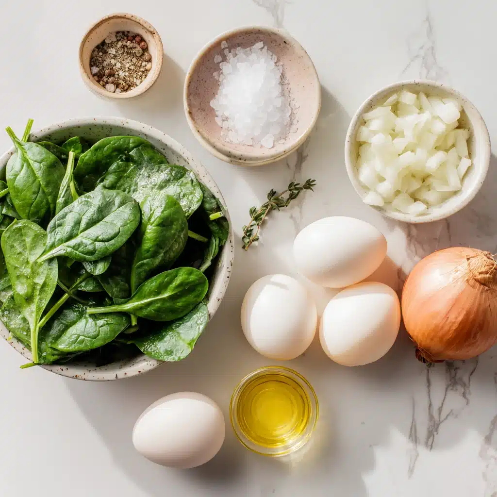 Ingredients for scrambled eggs with spinach on a marble counter