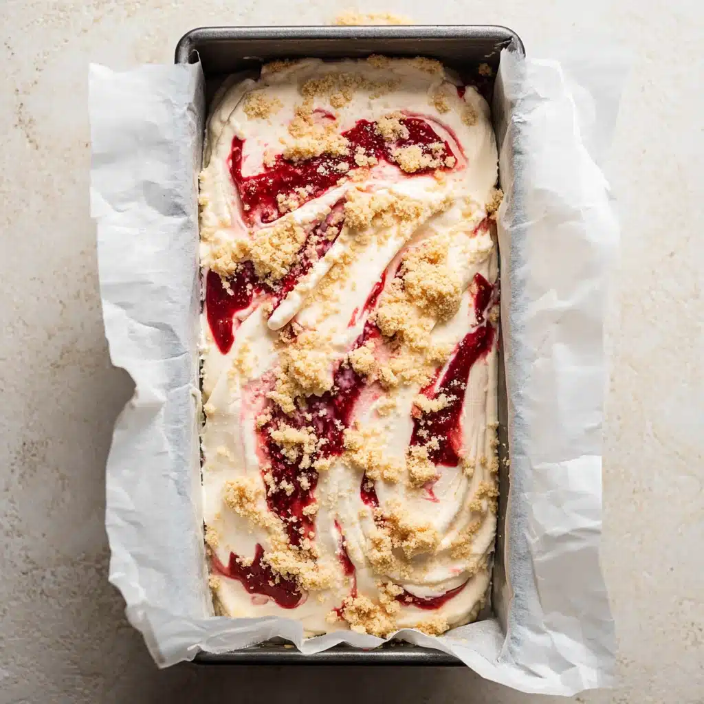 Scooping strawberry shortcake ice cream with swirl and crumb topping