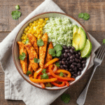 Healthy chicken fajita meal prep bowl with rice and vegetables.
