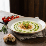 Creamy white chicken lasagna soup with basil pesto swirl.