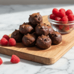 No-Bake Cottage Cheese Brownie Batter Protein Bites with raspberries.