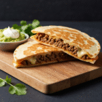 Golden brown keto beef quesadilla with melted cheese filling