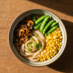 Rustic miso udon noodle soup with teriyaki mushrooms and vegetables.