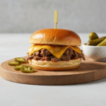 Slow cooker beef and cheddar sandwich on brioche bun