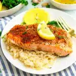Flaky salmon fillets garnished with fresh dill and lemon slices, nestled in a light herb-infused broth. Slow Cooker Herb Salmon