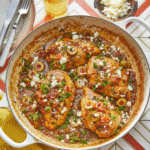 Juicy chicken thighs with olives, red onions, and herbs in a tomato-based sauce, Slow Cooker Mediterranean Chicken