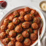Juicy turkey meatballs simmered in a rich tomato sauce, garnished with herbs and served with zucchini noodles. Slow Cooker Turkey Meatballs