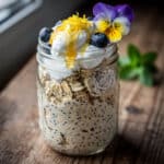 Creamy Greek yogurt lemon poppy seed oats in a clear glass jar.