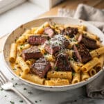 Cajun steak tips with cheesy rigatoni in a creamy Parmesan sauce.