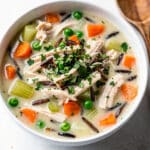 Creamy chicken and wild rice soup with vegetables in a rustic bowl