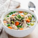 Creamy chicken and wild rice soup recipe in a rustic homemade bowl.