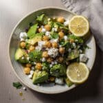 Creamy chickpea feta avocado salad in a rustic white ceramic bowl.