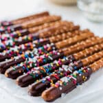 Homemade chocolate dipped pretzel rods with glossy coating and crispy texture.