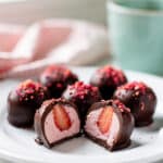 Decadent chocolate covered strawberry truffles with a creamy glossy shell.