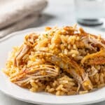 Creamy chicken and rice casserole with peas and carrots in a crockpot.
