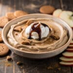 Creamy gingerbread cheesecake dip with gingersnap and apple dippers.