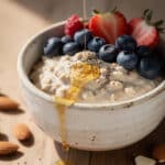 Creamy overnight oats with fresh berries and honey in a jar