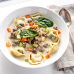 Creamy tortellini soup recipe with Italian sausage spinach and tomatoes