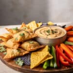 Crispy wontons with creamy salsa de queso dip and colorful dippers.