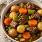 Crockpot beef stew recipe with tender beef carrots potatoes and peas