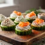 Crisp cucumber rounds topped with herbed cream cheese and fresh dill garnish.