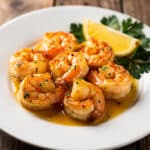Creamy garlic butter sauce coats crispy seared shrimp bites with lemon.