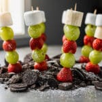 Festive Grinch fruit skewers with grapes bananas strawberries and marshmallows