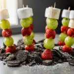 Festive Grinch fruit skewers with grapes bananas strawberries and marshmallows